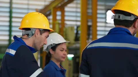Factory Workers and Engineers in Hardhats Discussing Operations in Plant. Stock Footage 343428712