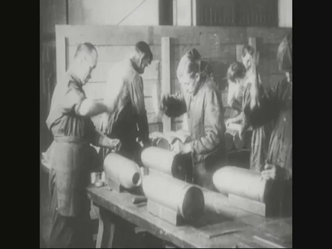 Factory workers are hammering on shells and officers majoring shells - 1918 Stock Footage 83657525