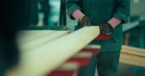 Factory workers are processing the board. Edged board in production. Woodworking Stock Footage 157855241
