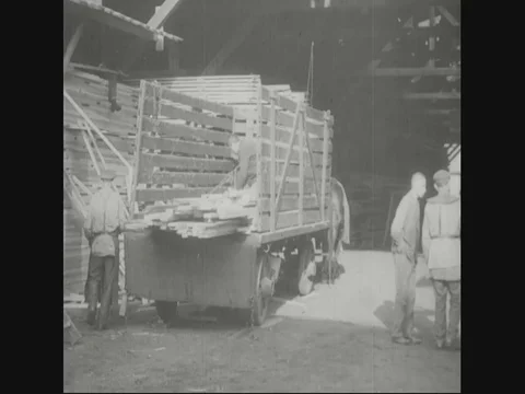 Factory workers are unloading wood from truck and workers cutting wood - 1918 Stock Footage 83657588
