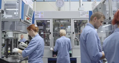 Factory Workers Assembling Rotors for Cars on an Assembly Line: Dolly Shot Stock Footage 153013505