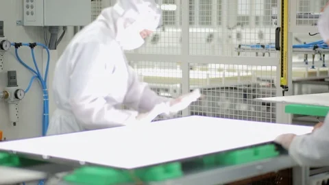 Factory workers on the assembly line of an electronic components manufacturer Stock Footage 105207598