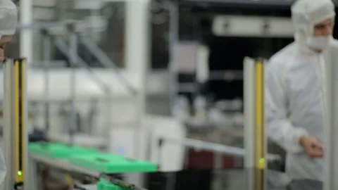 Factory workers on the assembly line of an electronic components manufacturer Stock Footage 105207911