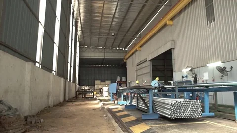 Factory Workers Cutting Aluminum Duct Pipes - Pan - Left To Right Stock Footage 79083182