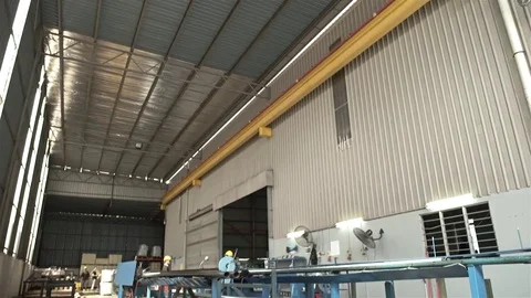 Factory Workers Cutting Aluminum Duct Pipes - Tilt Stock Footage 79083186