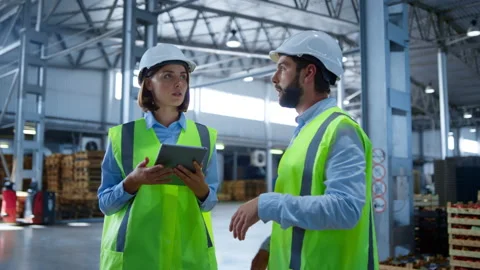 Factory workers discussing tablet information analysing production process Stock Footage 169880993