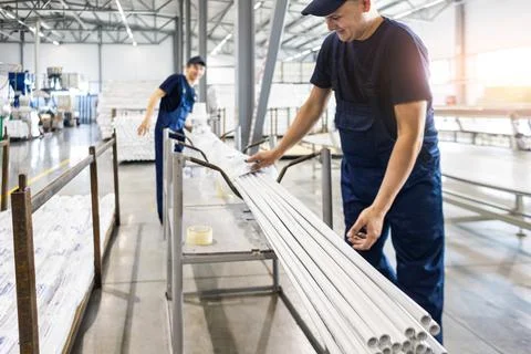 Factory workers engineer checks the quality of polypropylene pipes Stock Photos