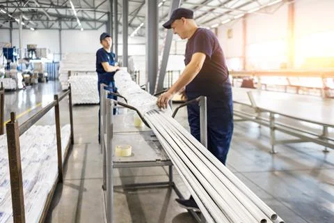 Factory workers engineer checks the quality of polypropylene pipes Stock Photos