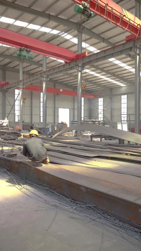 Factory Workers Handling Large Steel Plate with Overhead Crane in Metal Fabricat Stock Footage 339384282