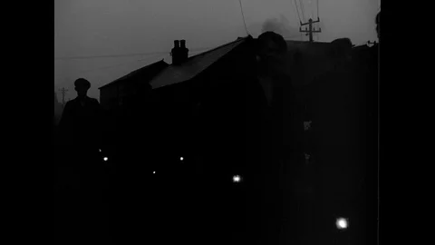 Factory workers leaving and going home in dark, South Wales, UK 1943 Stock Footage 133280306