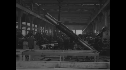 Factory workers lifts cannon through crane in ordnance factory - 1917-1918 Stock Footage 83661198