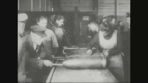 Factory workers measuring shells and officer inspecting shells in factory - 1918 Stock Footage 83657528