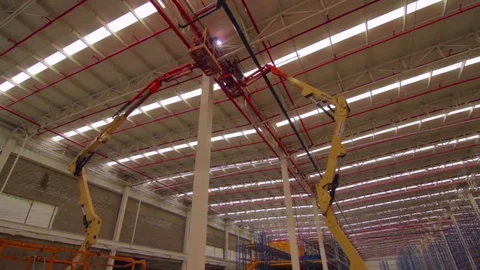 Factory workers on a mechanical lift 스톡 동영상 75166479