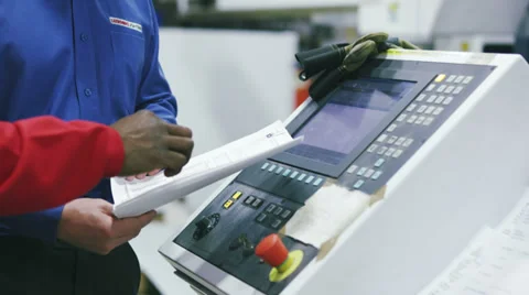 Factory workers operating machinery Stock Footage 32934068