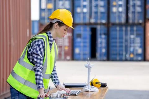 Factory workers or engineers holding light bulb and using tablet computer wit 写真素材
