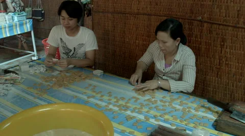 Factory workers packing coconut candy in Vietname Stock Footage 48153125