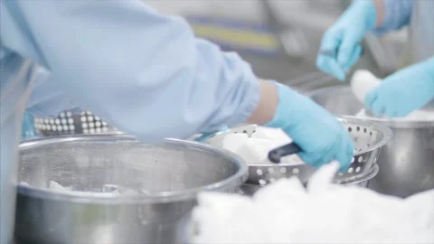 Factory workers process coconut meat for packaging. Stock Footage 159722714