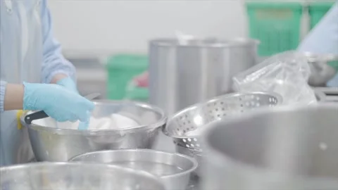 Factory workers process coconut meat for packaging. Stock Footage 159722752