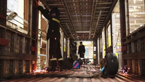 Factory workers in protective uniform and safety masks welding steel structures Stock Footage 202049068