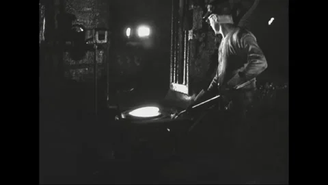 Factory workers stamp and drill steel automobile engine components 1937 Video stock 253409597