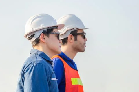 Factory workers working at the harbor, Engineering man team looking to the sky Фото