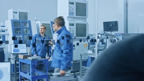In Factory Workshop Professional Workers Use High-Tech Industrial CNC Machinery Stock Footage 124305762