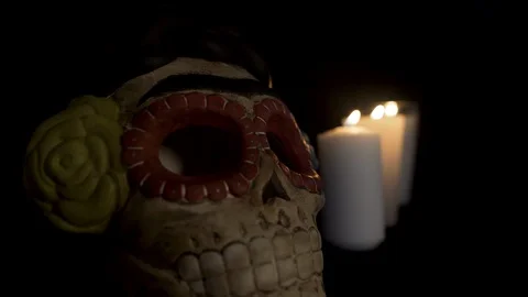 Fade in and Out light, over a skull with three candles light up on the back. Stock Footage 96675207
