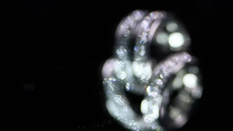 Fade In Close-up Of Engagement Silver Wedding Magic Rings Shine. Vertical Stock Footage 169084890