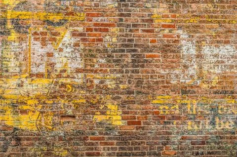 Faded Advertisement on a Brick Wall Foto stock
