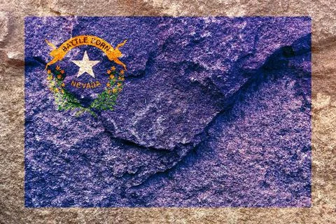 The faded Nevada state flag icon pattern isolated on weathered solid rock wal Fotos de archivo