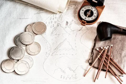 Faded old map with treasures coordinates, pirates coins and compass Stock Photos