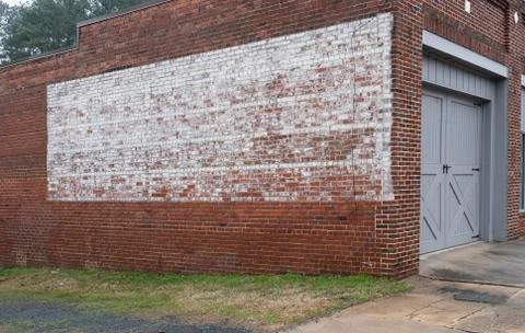 Faded painted sign on rustic old brick wall texture store or building Stock Photos