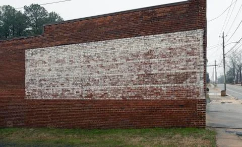 Faded painted sign on rustic old brick wall texture store or building Stock Photos