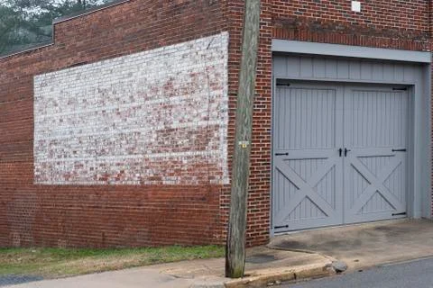 Faded painted sign on rustic old brick wall texture store or building Stock Photos