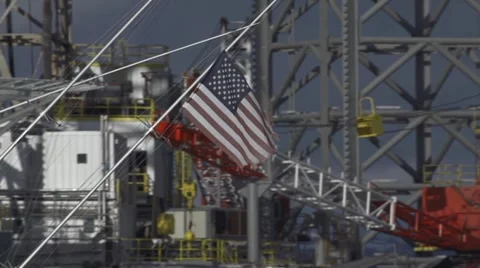 Faded Tattered US Flag Passing Oil &amp; Gas Rig at Harbor Video stock 12353337