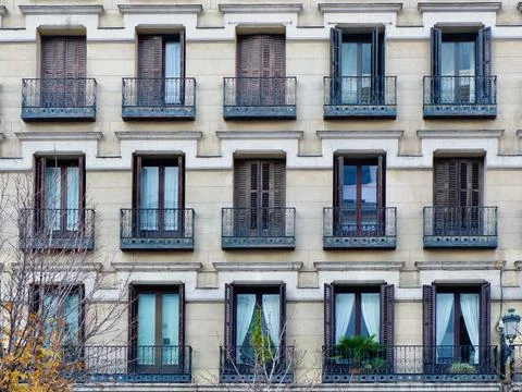 Faded windows with shutters on the classical old-fashioned facade in Opera .. Stock Photos