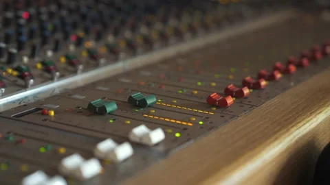 Faders, dials and knobs on a music studio mixing desk Stock-Footage 332134615