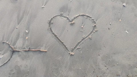 Fading heart with the waves on the beach Stock Footage 105661987