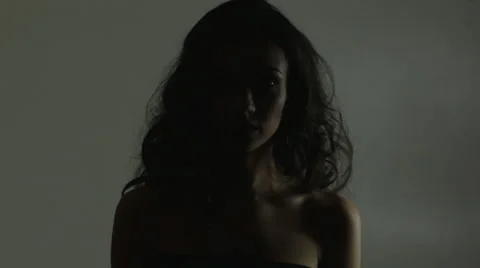 Fading out light on young pretty lady looking to camera 스톡 동영상 63095489