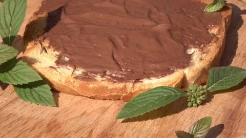 Fading rotation to final stop of single white bread slice with chocolate paste Stock Footage 99850651