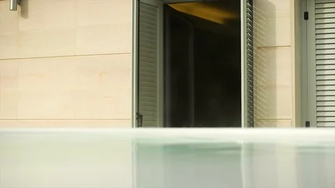 Fading shot of the water level in Jacuzzi hot tub pool with entrance behind 4k Stock Footage 94250646
