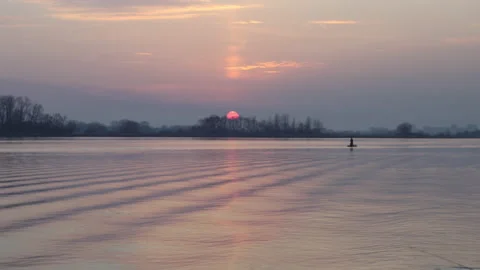 Fading sunset over the river, lake. Small waves in the water Stock Footage 142593137