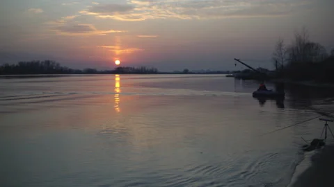 Fading sunset over the river, lake. Small waves in the water Stock Footage 142593311