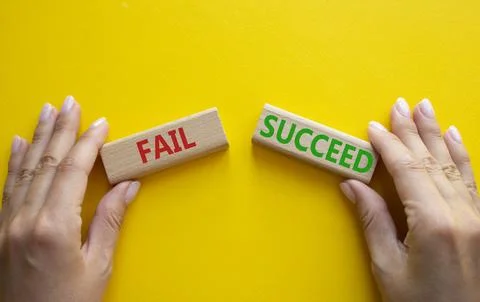 Fail or Succeed symbol. Concept word Fail or Succeed on wooden blocks. Busi.. Stock Photos