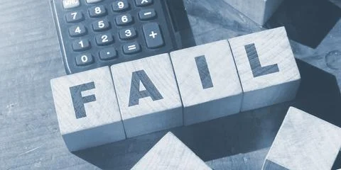Fail word from wooden blocks and calculator on desk. Business crisis concept Stockfoto's