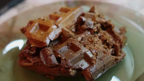 Failed attempt at making waffles on a plate at a kitchen table during breakfast Stock Footage 332961074