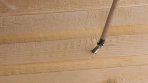 Failed attempt to screw a self-tapping screw into a wooden Board Stock Footage 131982287