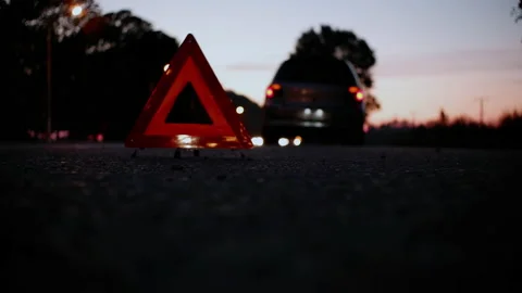 A failed car stands on the side of the road at night with the alarm on. An em Stock Footage 160930412