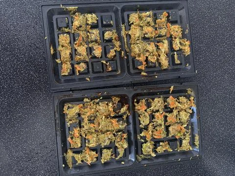 Failed to make vegetable waffles in the waffle iron. Recipe error, burnt food Stock Photos