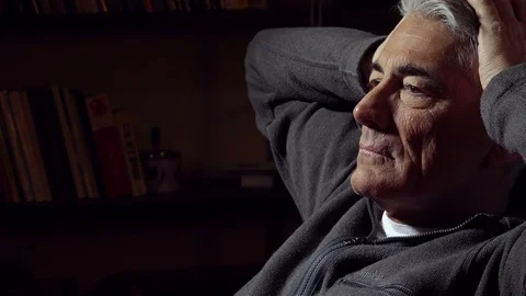 Failure: distressed and worried mid aged man sitting alone in the darkness Video stock 74424741